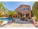 Exterior view of home showing the backyard pool, covered patio and surrounding desert landscaping at 408 E Silverwood Dr, Phoenix, AZ 85048