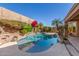 Inviting backyard pool with lush landscaping, featuring rock accents and mature palm trees for a private oasis at 408 E Silverwood Dr, Phoenix, AZ 85048