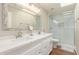 Bright bathroom features double sinks, white cabinetry, and a glass-enclosed shower at 408 E Silverwood Dr, Phoenix, AZ 85048