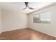 Bedroom with wood-look tile flooring and window view of the neighborhood at 408 E Silverwood Dr, Phoenix, AZ 85048