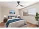 Bright bedroom features wood-look flooring, ceiling fan, and a large window for plenty of natural light at 408 E Silverwood Dr, Phoenix, AZ 85048