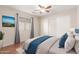 Relaxing bedroom with a ceiling fan, wood floors, and ample closet space at 408 E Silverwood Dr, Phoenix, AZ 85048