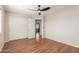 Bedroom featuring wood-look tile floor, ceiling fan, and a closet with sliding doors at 408 E Silverwood Dr, Phoenix, AZ 85048