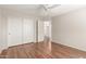 Bedroom features wood-look tile flooring, ceiling fan, and a closet with sliding doors at 408 E Silverwood Dr, Phoenix, AZ 85048