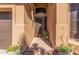 Elegant entryway with a decorative iron door and potted plants, enhancing curb appeal at 408 E Silverwood Dr, Phoenix, AZ 85048