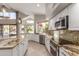Bright kitchen with stainless steel appliances, granite countertops, and a view to the backyard at 408 E Silverwood Dr, Phoenix, AZ 85048