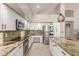 Well-lit kitchen with granite countertops, stainless steel appliances, and light-colored tile flooring at 408 E Silverwood Dr, Phoenix, AZ 85048