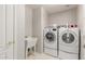 Bright laundry room features a modern washer and dryer, plus a utility sink for added convenience at 408 E Silverwood Dr, Phoenix, AZ 85048