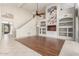 Spacious living room featuring built-in shelving, wood floors, and large windows at 408 E Silverwood Dr, Phoenix, AZ 85048
