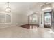 Living room showcasing tile flooring, large windows, and a decorative wrought iron front door at 408 E Silverwood Dr, Phoenix, AZ 85048