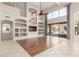 Open living room featuring built-in shelves, tile flooring, and backyard access at 408 E Silverwood Dr, Phoenix, AZ 85048