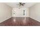 Bright living room featuring hardwood floors, with views into the laundry room and primary bathroom at 408 E Silverwood Dr, Phoenix, AZ 85048