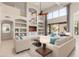 Spacious living area with built-in shelving, large windows, and elegant furnishings at 408 E Silverwood Dr, Phoenix, AZ 85048