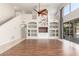 Bright living room with built-in shelves, a ceiling fan, and expansive backyard views at 408 E Silverwood Dr, Phoenix, AZ 85048