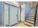 Bright foyer with staircase and a windowed front door, offering a welcoming entrance to the home at 4702 E Lavender Ln, Phoenix, AZ 85044