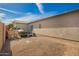 Backyard featuring a brick-paved patio, gravel, block wall and blue sky at 502 E Mountain View Rd, San Tan Valley, AZ 85143
