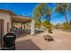 Backyard with a covered patio with dining, cooking area, a fire pit, and pool with rock detail at 502 E Mountain View Rd, San Tan Valley, AZ 85143