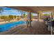 Covered patio looks out to the refreshing backyard pool and rock waterfall feature at 502 E Mountain View Rd, San Tan Valley, AZ 85143