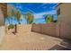 Backyard featuring a brick-paved patio, gravel, block wall and blue sky at 502 E Mountain View Rd, San Tan Valley, AZ 85143