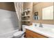 Bathroom with white toilet and sink, and tub with cream colored shower curtain at 502 E Mountain View Rd, San Tan Valley, AZ 85143