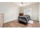 Bedroom with hardwood floors, shuttered windows and a animal print blanket on the bed at 502 E Mountain View Rd, San Tan Valley, AZ 85143