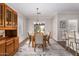 Elegant dining room with a wooden table, six chairs, and a decorative chandelier at 502 E Mountain View Rd, San Tan Valley, AZ 85143