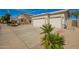 Wide driveway leading to a two-car garage of a home with desert landscaping at 502 E Mountain View Rd, San Tan Valley, AZ 85143
