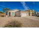 Exterior showcasing a charming single-Gathering home with desert landscaping and a two-car garage at 502 E Mountain View Rd, San Tan Valley, AZ 85143