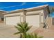 Garage exterior featuring a three-car garage with desert landscaping at 502 E Mountain View Rd, San Tan Valley, AZ 85143