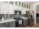 Updated kitchen featuring sleek cabinets, stainless steel appliances, and subway tile backsplash at 502 E Mountain View Rd, San Tan Valley, AZ 85143