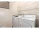 A bright laundry room with a modern washing machine and dryer at 502 E Mountain View Rd, San Tan Valley, AZ 85143