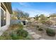 Backyard featuring a built-in grill, lush landscaping, and a stone pathway at 6426 N 27Th St, Phoenix, AZ 85016