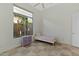 Bright bedroom featuring a twin bed and a window overlooking the lush outdoor greenery at 6426 N 27Th St, Phoenix, AZ 85016