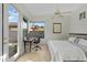 A well-lit bedroom featuring a bed, desk area, and a view of the outdoors at 6426 N 27Th St, Phoenix, AZ 85016