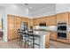 Bright kitchen with stainless steel appliances, center island with bar seating, and ample cabinet space at 6426 N 27Th St, Phoenix, AZ 85016