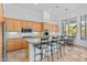 Well-lit kitchen with a breakfast bar, wooden cabinetry, and stainless steel appliances at 6426 N 27Th St, Phoenix, AZ 85016
