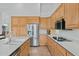 Bright kitchen boasts stainless steel appliances, wood cabinets, and quartz countertops at 6426 N 27Th St, Phoenix, AZ 85016