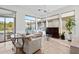 Bright living room featuring large windows, comfortable seating, and a view of the backyard at 6426 N 27Th St, Phoenix, AZ 85016
