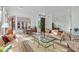 Sunlit living space with a sofa set, dining table, and a large window view to the outdoors at 6426 N 27Th St, Phoenix, AZ 85016