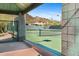 Tennis court with mountain views, a covered viewing area, and a net at 6426 N 27Th St, Phoenix, AZ 85016