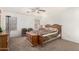 This bedroom offers carpeted floors, a ceiling fan, and a warm color palette at 665 E Winchester Way, Chandler, AZ 85286