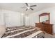 This bedroom features an ensuite bathroom, a ceiling fan, and lots of natural light at 665 E Winchester Way, Chandler, AZ 85286