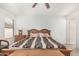 This bedroom features a ceiling fan, carpeted floor, and warm inviting atmosphere at 665 E Winchester Way, Chandler, AZ 85286
