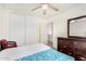 This bedroom features a blue floral mattress, a ceiling fan, and a standard closet at 665 E Winchester Way, Chandler, AZ 85286
