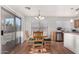 Cozy dining area with table, chandelier, and sliding glass door access to the backyard at 665 E Winchester Way, Chandler, AZ 85286