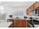 Modern kitchen featuring stainless steel appliances, granite countertops, and ample cabinet space at 665 E Winchester Way, Chandler, AZ 85286