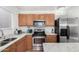 Modern kitchen featuring stainless steel appliances, granite countertops, and ample cabinet space at 665 E Winchester Way, Chandler, AZ 85286