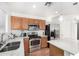 Modern kitchen featuring stainless steel appliances, granite countertops, and ample cabinet space at 665 E Winchester Way, Chandler, AZ 85286