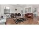 Bright living room with wood floors, large windows, and neutral color palette at 665 E Winchester Way, Chandler, AZ 85286