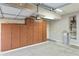 Garage interior with built-in storage cabinets and a water softener system at 6822 E Portia St, Mesa, AZ 85207